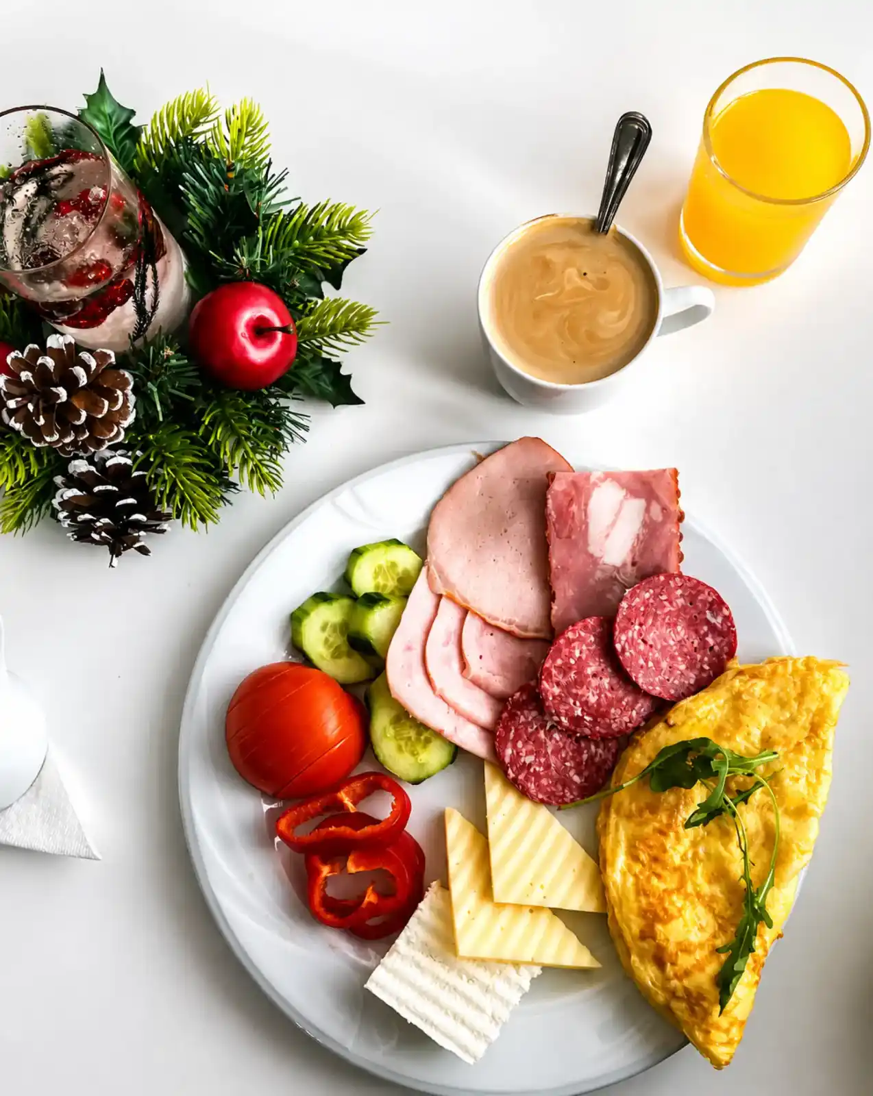 Breakfast plate with omelette, cold cuts, cheese, coffee and orange juice