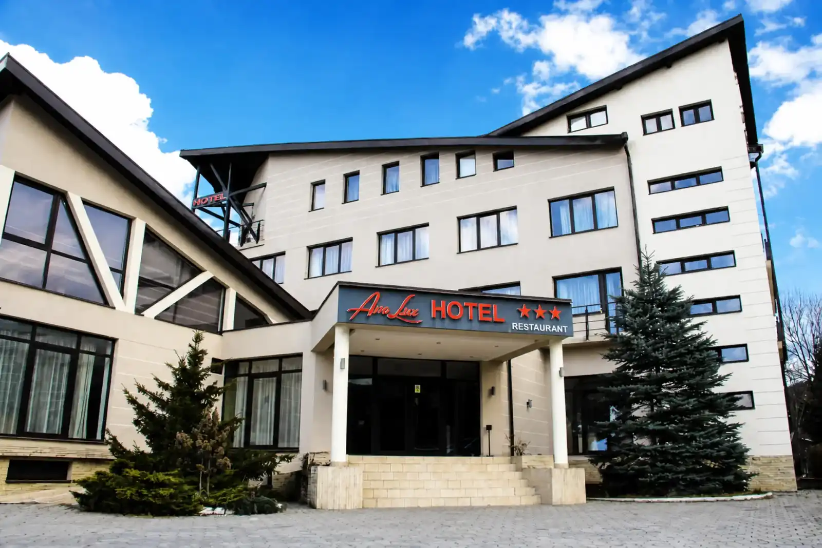 Hotel Ave Lux exterior in Brașov with the entrance canopy and hotel sign